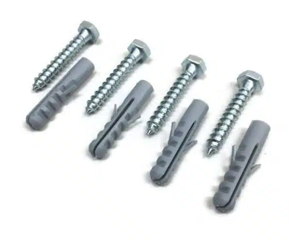 Various sizes screws and wall anchors on white background.