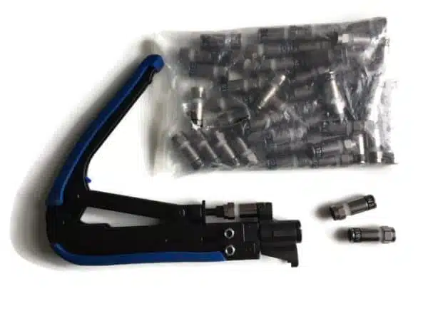 Crimping tool and assorted electrical connectors on white.
