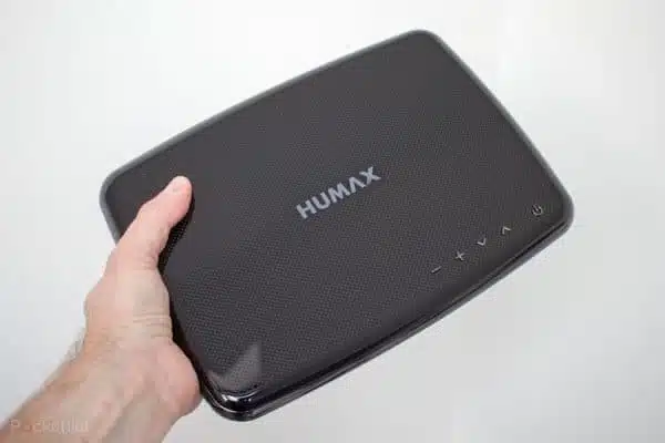 Hand holding HUMAX digital device.