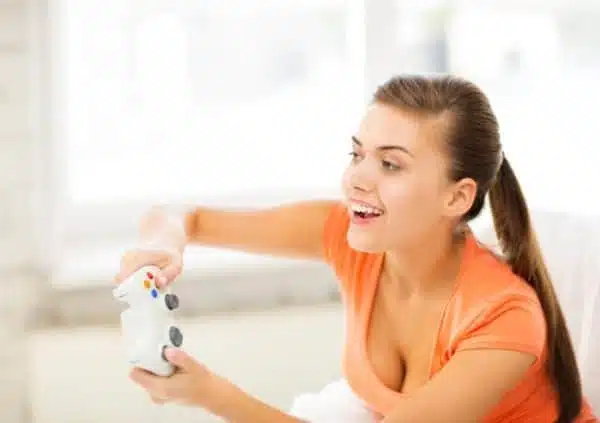 Woman playing with a white game controller.