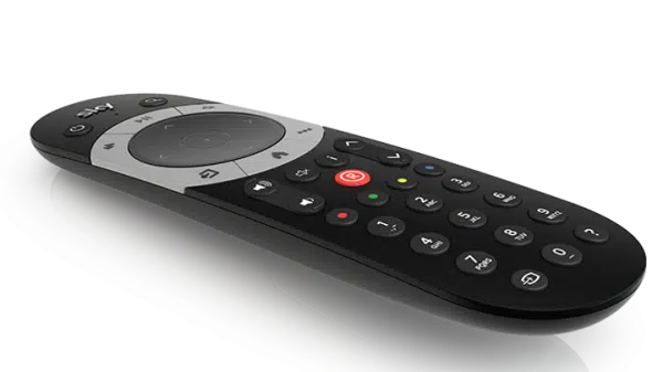 Modern black streaming TV remote control on dark background.