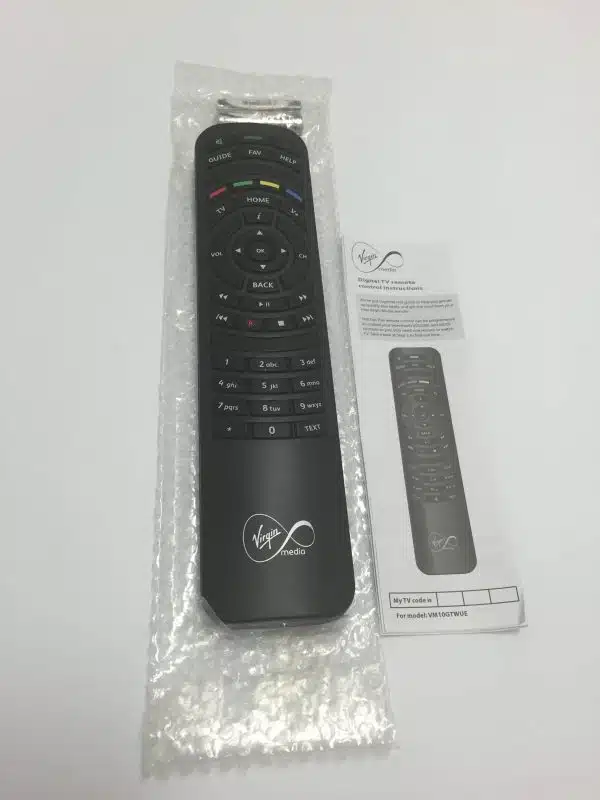Virgin Media TV remote and instruction manual on table.