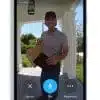 Delivery person at door with package, smart doorbell view.