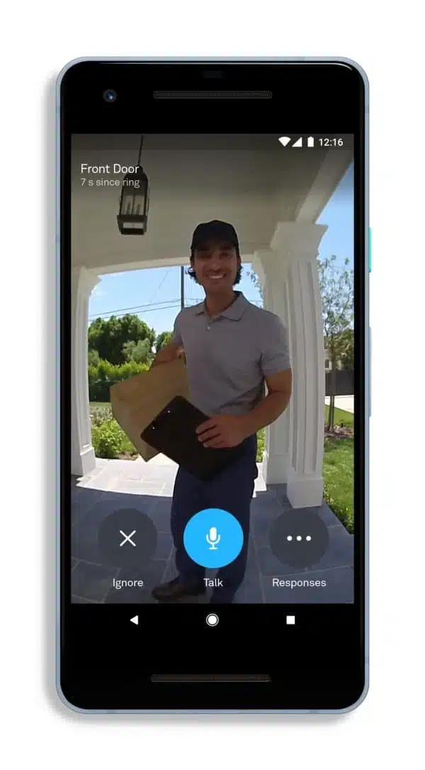 Delivery person at door with package, smart doorbell view.