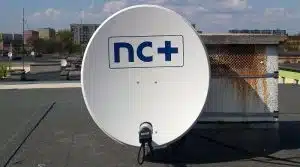 NC+ satellite dish on rooftop.