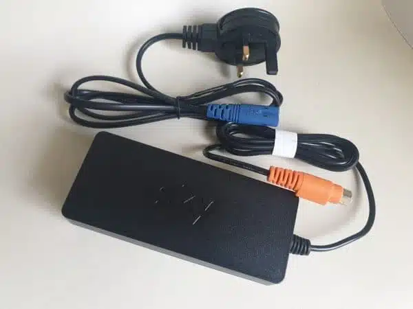 Black laptop charger with UK plug and connected cables.